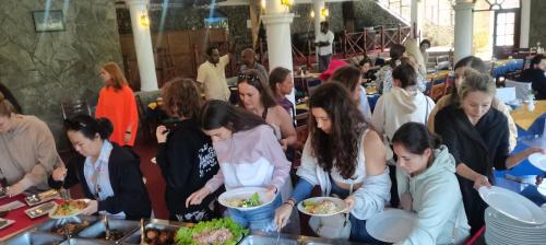 a group of people eating food at a party at Hotel Silver Falls - Nuwara Eliya in Nuwara Eliya