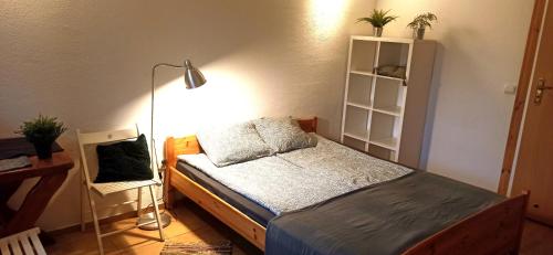 a bedroom with a bed and a lamp at Przystań Tło dla Mew in Rydzewo