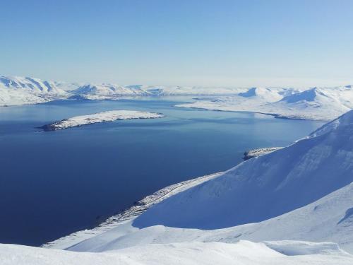 an aerial view of a lake in the snow at Klara Guesthouse in Ólafsfjörður