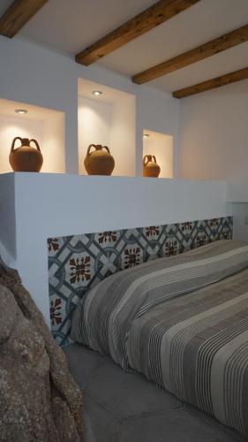 a bedroom with a bed with a light above it at Li Petri Manni in Olbia