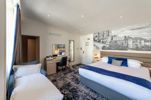 a hotel room with two beds and a desk at Dover Marina Hotel & Spa, Tapestry Collection by Hilton in Dover