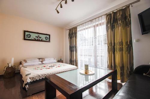 a living room with a bed and a glass table at Willa Dunajec in Zakopane