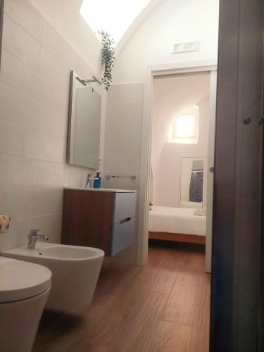 a white bathroom with a sink and a toilet at 1820 Marè in Molfetta