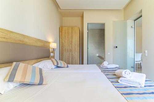 a bedroom with two beds with towels on them at Theo Star Beach Hotel in Malia