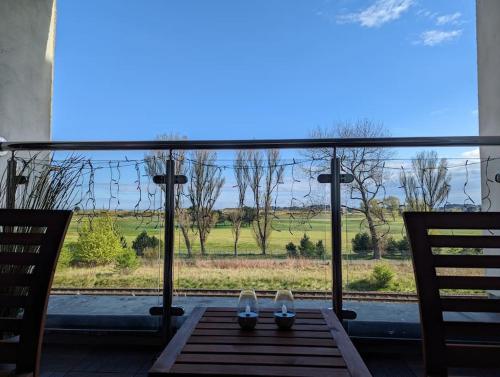 a pair of shoes sitting on a table in front of a window at Beautiful 2 bedroom flat overlooking golf course in Carnoustie