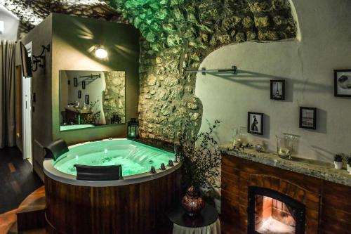 a large bathroom with a tub with a fireplace at Vicolo72 in Calitri