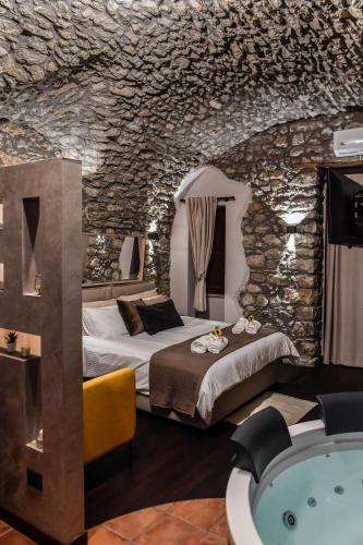 a hotel room with a bed and a bath tub at Vicolo72 in Calitri