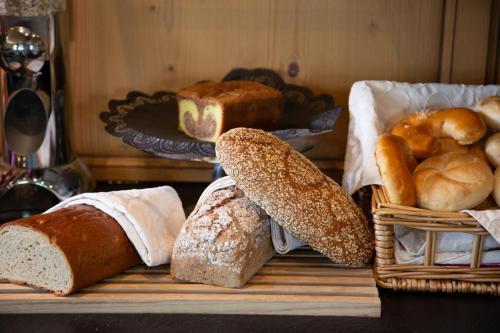 a table with various types of bread on it at Hotel Walisgaden superior in Damuls