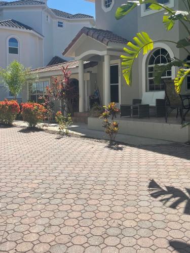 a house with a brick driveway in front of a house at Siesta Key Bay View Beach Access in Siesta Key