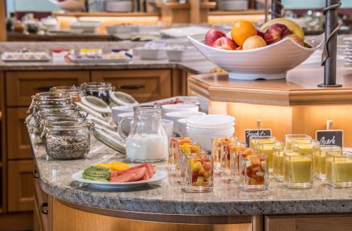 a counter with a bunch of different types of food at Wellness Privathotel Post an der Therme in Badenweiler