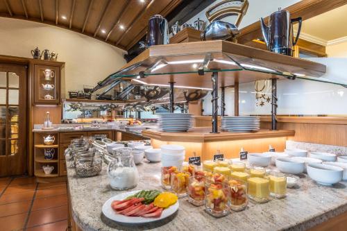 a kitchen with a bunch of food on a counter at Wellness Privathotel Post an der Therme in Badenweiler