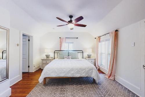 a bedroom with a bed and a ceiling fan at The Pink House on Main - Upper in Eureka Springs