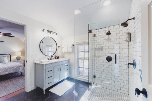 a white bathroom with a sink and a shower at The Pink House on Main - Upper in Eureka Springs