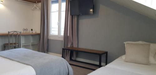 a hotel room with a bed and a window at Hôtel Terminus in Luz-Saint-Sauveur