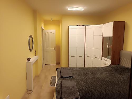 a bedroom with a bed and a dresser and a mirror at Apartament Tzar Kaloyan in Burgas