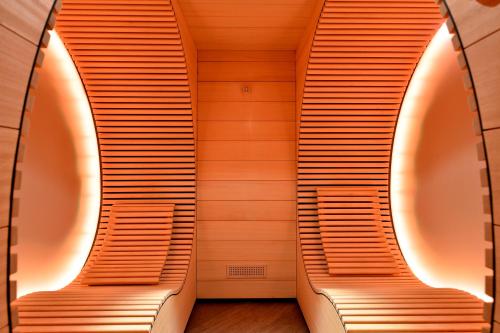 two benches in a room with wooden walls at Matterhorn Lodge Boutique Hotel & Apartments in Zermatt
