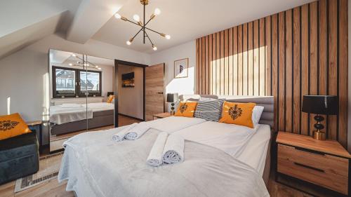 una camera da letto con un grande letto con asciugamani di Apartamenty Sun & Snow Resorts C Białka Tatrzańska z sauną a Białka