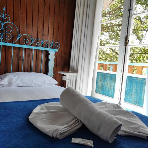 Ένα ή περισσότερα κρεβάτια σε δωμάτιο στο Hotel Chácara das Flores