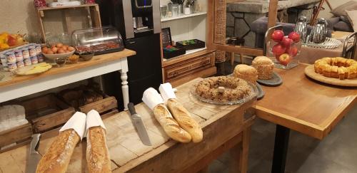 a kitchen with a table with bread and other foods at Hôtel Terminus in Luz-Saint-Sauveur