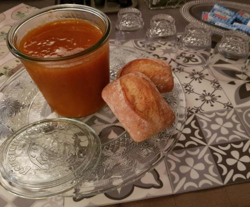 a glass plate with donuts and a drink on a table at Hôtel Terminus in Luz-Saint-Sauveur