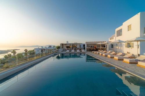 a large swimming pool with a view of the ocean at Sonia in Mikonos