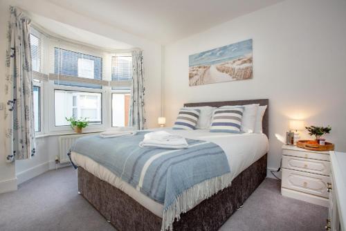 a bedroom with a large bed and a window at Rose Cottage in Sidmouth