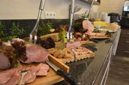 a buffet line with different types of meats and other foods at Hotel Olivia Medical SPA in Skomielna Czarna
