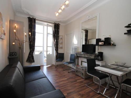 un salon avec un canapé et une table dans l'établissement Charmant Studio Central avec Balcon et Wi-Fi - Mont-Dore - FR-1-608-171, à Le Mont-Dore