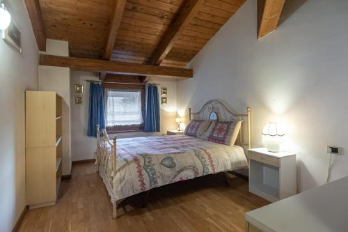 Postel nebo postele na pokoji v ubytování DolomiApartments - Casa Margherita