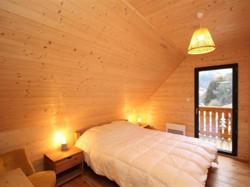 a bedroom with a bed in a wooden cabin at Le Mont-Dore: Splendide Chalet 5 Chambres avec Terrasse, Garage Double, et WiFi - FR-1-608-188 in Le Mont-Dore