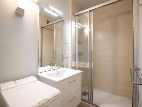 une salle de bain avec un lavabo blanc et une douche dans l'établissement Charmant T2 avec Balcon et Wi-Fi au Mont-Dore, Proche Centre et Thermes - FR-1-608-193, à Le Mont-Dore
