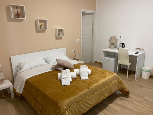 a bedroom with a bed with two towels on it at G&G Home in Cosenza
