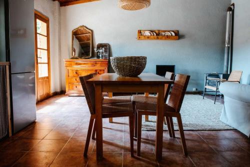 a dining room with a wooden table and chairs at La Viña. Casa rural en el campo in Tordera