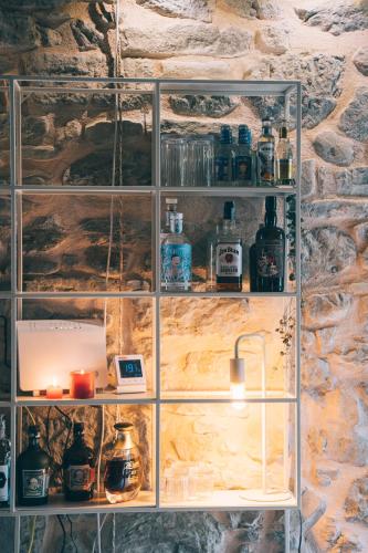 a glass shelving unit in a stone wall at Casa immersa nelle colline romagnole in Civorio
