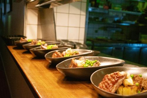 a row of bowls of food on a counter at Hotel Hans Egede in Nuuk