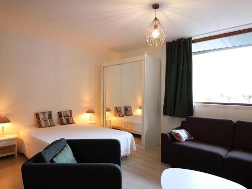 ein Schlafzimmer mit einem Bett, einem Sofa und einem Bett in der Unterkunft Appartement Mont-Dore, 2 pièces, 6 personnes - FR-1-608-175 in Le Mont-Dore