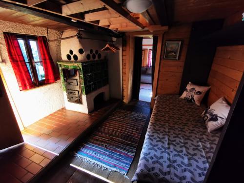an attic room with a bed and a fireplace at Schnaitstadl-Alm in Krispl