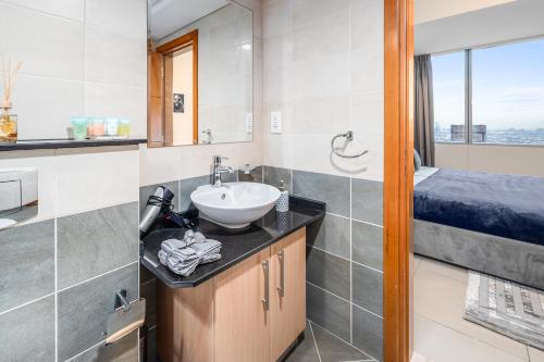 a bathroom with a sink and a bed at Breathtaking sea-view condo in Dubai Marina - Palm Views! in Dubai