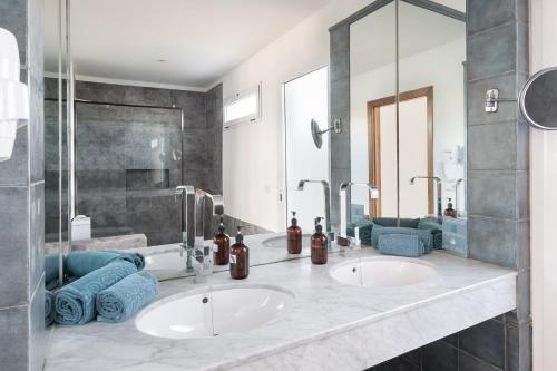 two sinks in a bathroom with two mirrors at Dreamplace Bocayna Village in Playa Blanca