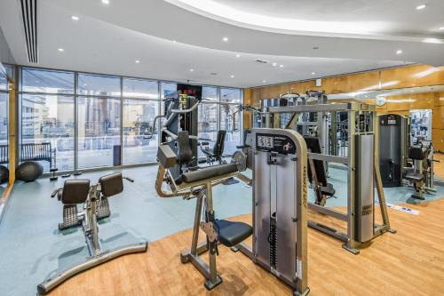 a gym with treadmills and cardio equipment in a building at Breathtaking sea-view condo in Dubai Marina - Palm Views! in Dubai