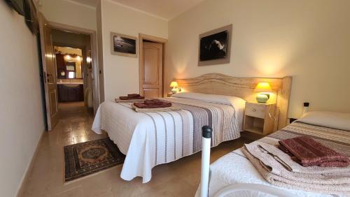 een slaapkamer met twee bedden met witte dekens erop bij Villa Anna Salento in Presicce