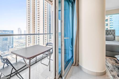 a table and chairs on a balcony with a view at Breathtaking sea-view condo in Dubai Marina - Palm Views! in Dubai