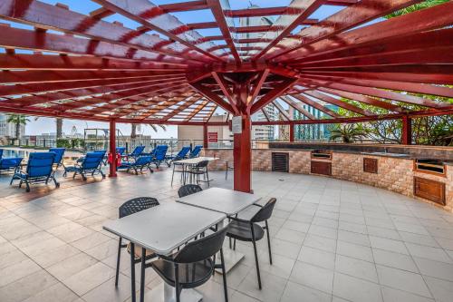 a patio with tables and chairs under a red roof at Breathtaking sea-view condo in Dubai Marina - Palm Views! in Dubai
