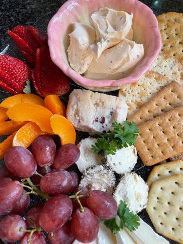 a plate of food with cheese crackers fruit and dip at Modjadji Estate Lodge & Spa in Grietjie Nature Reserve