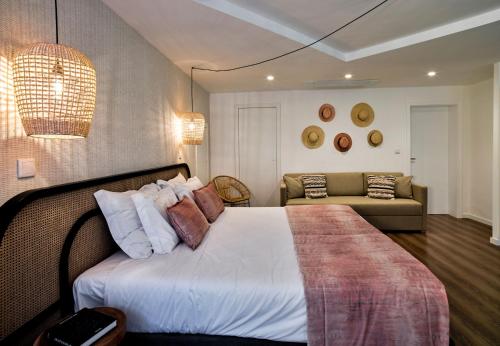 a bedroom with a bed and a couch at The Bastion Elvas Apartments in Elvas
