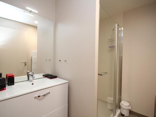 ein weißes Badezimmer mit Waschbecken und Dusche in der Unterkunft Bel appartement T3 avec WiFi et parking, Mont-Dore - FR-1-608-13 in Le Mont-Dore