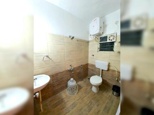 a bathroom with a toilet and a sink at Sai Shreyas Residency, Best Hotel near Bangalore Airport in Bengaluru