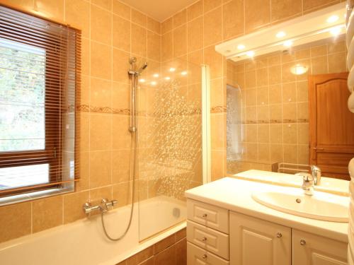 a bathroom with a shower and a sink and a tub at Appartement T3 avec Parking à La Bourboule, à 500m des Thermes et du Centre, WiFi Inclus - FR-1-608-14 in La Bourboule