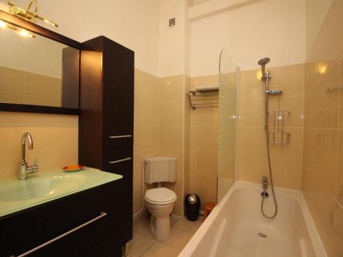 ein Badezimmer mit Badewanne, Toilette und Waschbecken in der Unterkunft Appartement T3 au Mont-Dore, Centre, 3 étoiles, balcon, ascenseur, WIFI, proche Thermes et navette ski - FR-1-608-17 in Le Mont-Dore