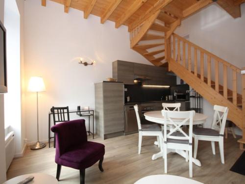 une cuisine et une salle à manger avec une table et des chaises dans l'établissement Mont-Dore T3 Duplex avec WIFI et Animaux admis - FR-1-608-26, à Le Mont-Dore